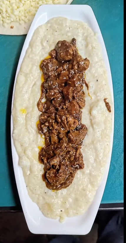 Creamy mashed potatoes topped with buff at QnQ Cafe Sainikpuri